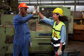 workers or engineers giving high five pose in the factory