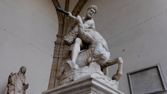 The marble statue of Hercules and the Centaur Nesso located in the Loggia dei Lanzi to the right of Palazzo Vecchio in Florence