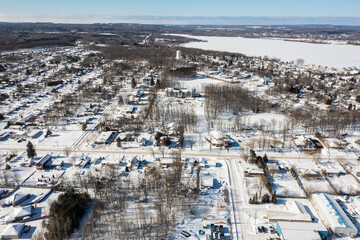 Fototapeta premium Discover Barrie's tranquil outskirts with mesmerizing aerial views of Lake Simcoe. These drone photos capture the town's scenic beauty, making them ideal for local businesses, tourism agencies, and na