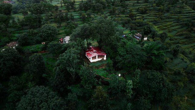 An isolated village during monsoon season with fog and mist.