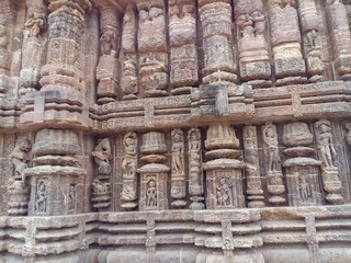 A wall full of rock cut art statues at the famous Sun Temple of Konark, Odisha, India