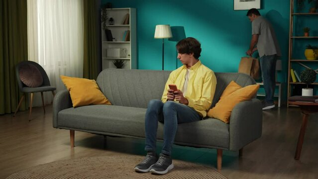 Full-size video of a homosexual couple. One enters the room, greeting his partner, who seems jealous, stressed about something he discovered. The first man tries to explain himself calmly.