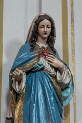 A colorful statue of the Virgin Mary in the interior.