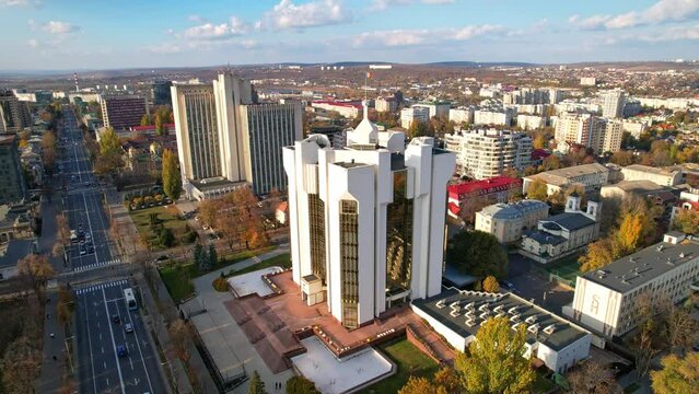 Panoramic aerial drone view of official residence of President with flag of Republic of Moldova. Presidential Palace in Chisinau with Multiple office and residential buildings on background. 4K video