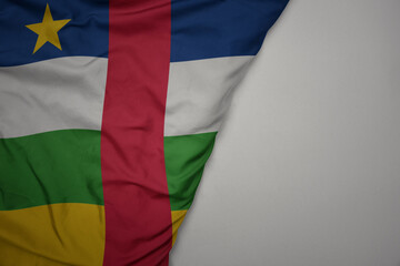 Obraz premium big waving national colorful flag of central african republic on the gray background.