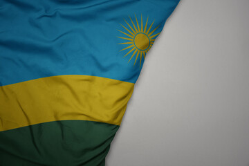 big waving national colorful flag of rwanda on the gray background.