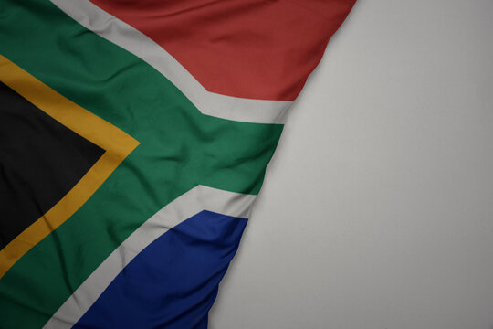 big waving national colorful flag of south africa on the gray background.