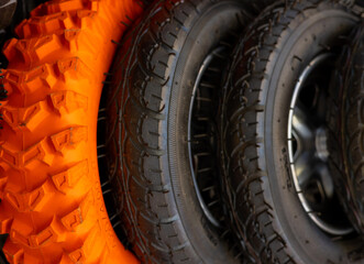 bike front wheel motorcycle tires in row for sale, shop store.orange black mountain tyre.