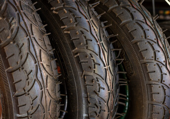 bike front wheel motorcycle tires in row for sale, shop store.orange black mountain tyre.