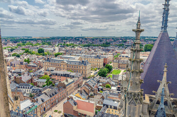 Fototapeta premium Aerial view from top of Amiens Cathedral with fleche spire and panorama of Amiens old historical city centre and outskirts districts, Somme department, Hauts-de-France Region, Northern France