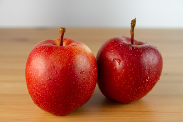 Red apples on a wooden table, close-up, shallow depth of field