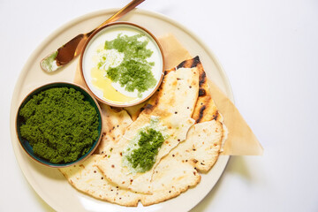 Vegan recipes with tortillas and wolffia spread on wooden plate. Wolffia is the nutrient-rich...