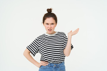 Portrait of angry woman complaining, raising one hand and shrugging looking frustrated, waiting for...