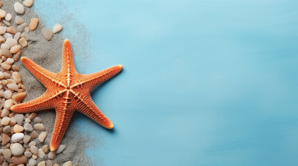 Fototapeta na wymiar Orange starfish with sand and stones on a blue background, marine banner with copy space