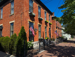 Old residential buildings along brick sidewalks maintain an old world charm in German Village, a...