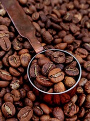 Coffee measuring spoon with hand-roasted coffee beans