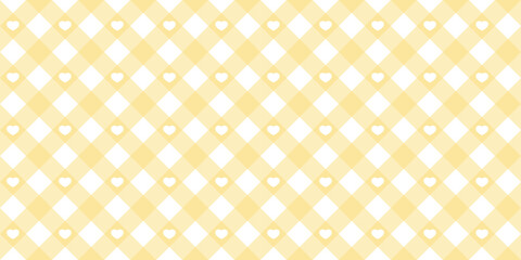 Fototapeta premium Gingham heart diagonal seamless pattern in yellow pastel color. Vichy plaid design for Easter holiday textile decorative. Vector checkered pattern for fabric - picnic blanket, tablecloth, dress