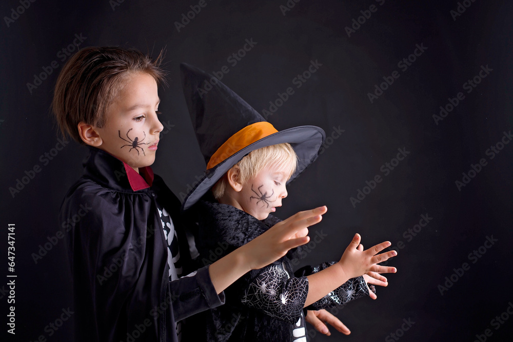 Poster Children. brothers, dressed for Halloween, playing at home, isolated image