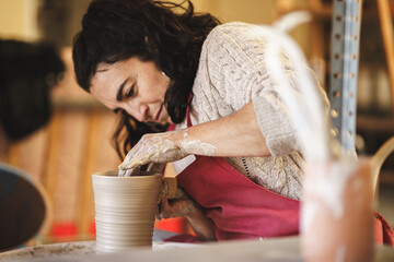 woman hands of a potter on her workshop