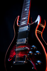 Close up of a guitar with black background