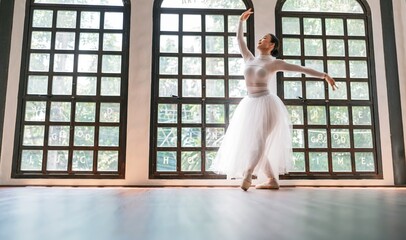 Asian girl ballet dancer creative performance with white skirt demonstrating dancing skill Young...