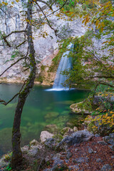 autumn season and ilica waterfall between the rocks and the colors of nature