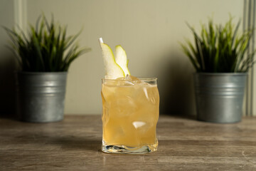 Alcoholic pear cocktail on wooden table