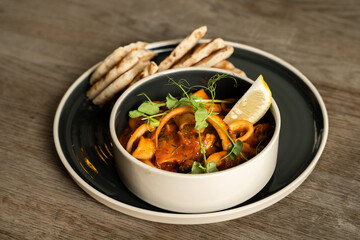 Calamari with spicy tomato sauce and Greek pita bread