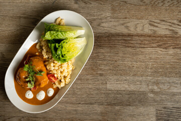 Chicken with paprika sauce, noodles with egg and sour cream, salad with vinegary