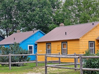 Fototapeta na wymiar Bright gold and blue cabins with timber fencing 