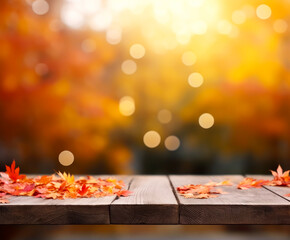 Naklejka na ściany i meble Autumn or Thanksgiving background with rustic wooden planks, leaves and yellow, orange fall colors on the blurred-out trees on the background. Texture with copy space.
