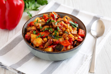 Homemade Eggplant Potato Tomato Stew with Parsley in a Bowl, side view.
