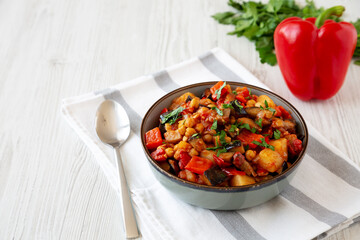 Homemade Eggplant Potato Tomato Stew with Parsley in a Bowl, side view.