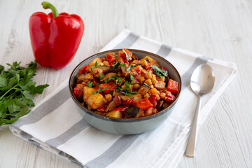 Homemade Eggplant Potato Tomato Stew with Parsley in a Bowl, side view.
