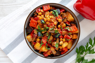 Homemade Eggplant Potato Tomato Stew with Parsley in a Bowl, top view. Flat lay, overhead, from...