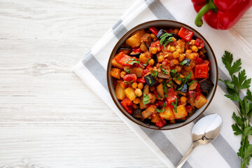 Homemade Eggplant Potato Tomato Stew with Parsley in a Bowl, top view. Flat lay, overhead, from above. Copy space.