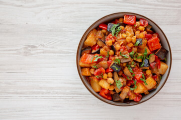 Homemade Eggplant Potato Tomato Stew with Parsley in a Bowl, top view. Flat lay, overhead, from above. Copy space.