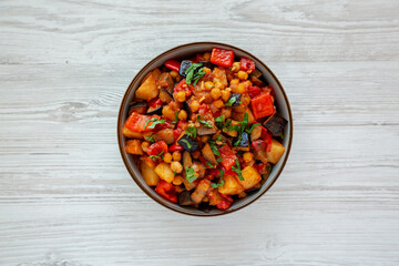 Homemade Eggplant Potato Tomato Stew with Parsley in a Bowl, top view. Flat lay, overhead, from above.