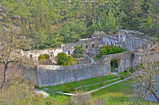 A wide view of the historic Sourp Magar Armenian Monastery in Cyprus, nestled amidst green hills.