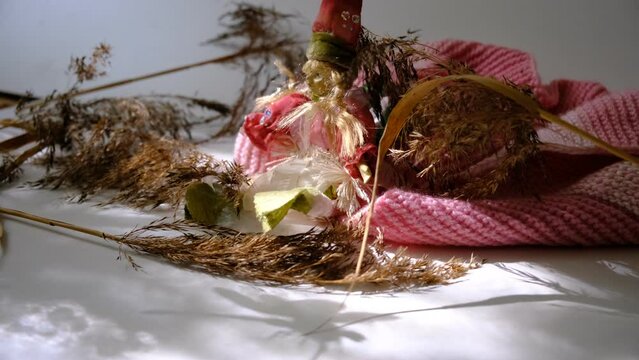 Boho style. Backgroundshadow of dragonfly, dry flowers and beige knitted dress, cute doll. Home sweet Home
