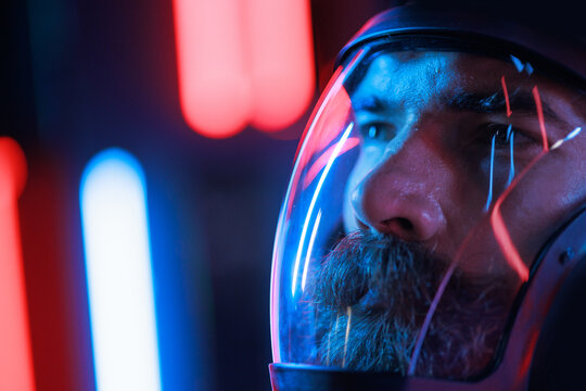 Portrait of futuristic astronaut.  conception. Augmented reality game, future technology, astronomy, AI concept. Neon blue and red light. Dark background.