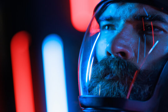 Portrait of futuristic astronaut.  conception. Augmented reality game, future technology, astronomy, AI concept. Neon blue and red light. Dark background.