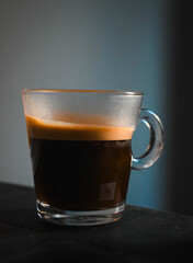 cup of espresso coffee on dramatic lighting blue and cyan