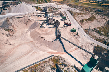 Stone crushing plant aerial view. Conveyors, silos and other structures of open pit limestone mine....