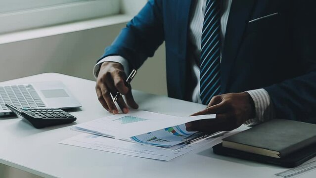 Close up of Business team analyzing income charts and graphs with modern laptop computer. Business analysis and strategy concept.