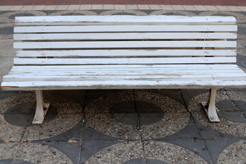 Bench for rest in a city park on the shores of the Mediterranean Sea.