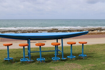 Bench for rest in a city park on the shores of the Mediterranean Sea.