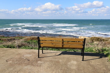 Naklejka na ściany i meble Bench for rest in a city park on the shores of the Mediterranean Sea.