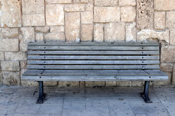 Bench for rest in a city park on the shores of the Mediterranean Sea.
