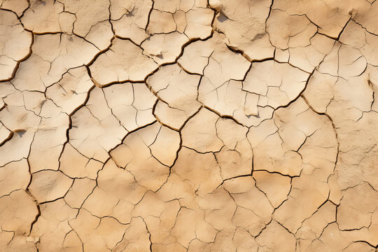 Cracked dry clay soil texture or background. Effects of climate change, desertification and droughts
